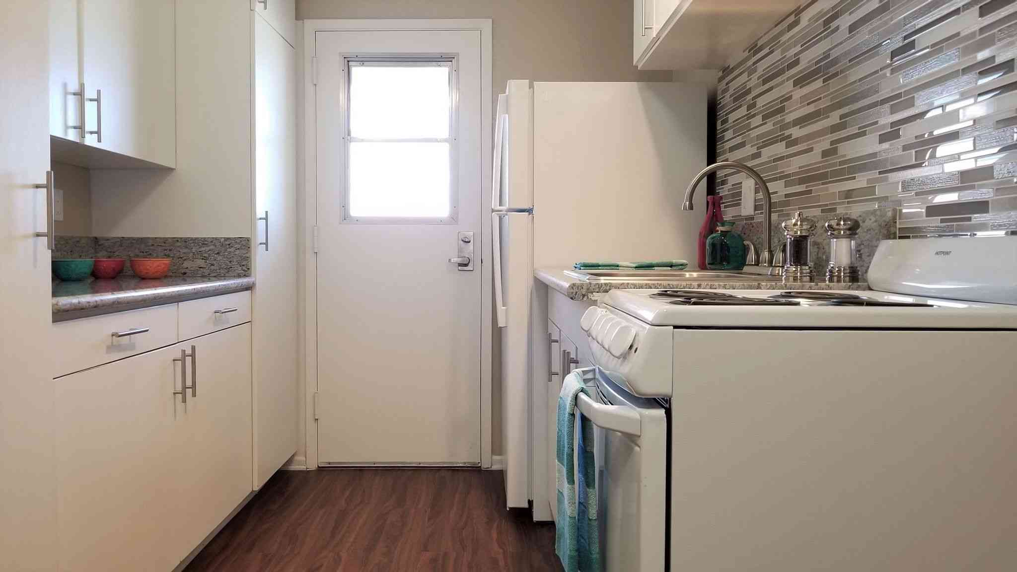 renovated kitchen with mosaic backsplash